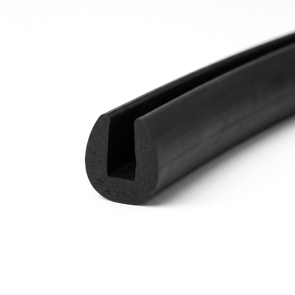 Black EPDM edge trim profile coiled, angled view of rounded egg-shaped groove