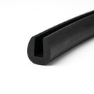 Black EPDM edge trim profile coiled, angled view of rounded egg-shaped groove