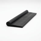 Black rubber curled-lip extrusion with flat wing, angled studio shot