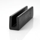 Black EPDM U-channel profile standing upright, plain white background shot of square-ended block