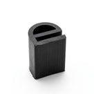 Studio shot of a cut length of black rubber D-section seal standing upright on its barbed base.
