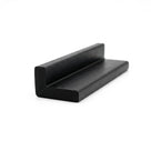 Short cut length of black rubber angle extrusion angled on white background
