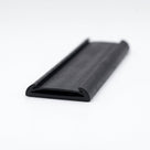 Black rubber flat strap with curled edges, angled studio shot