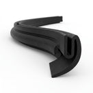 Black EPDM U-channel profile coiled, curved tail end visible in close-up