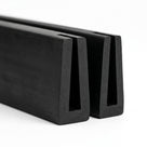 Black EPDM U-channel profile pieces, end-on view of tapered square-ended groove