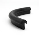 Curved length of black solid neoprene T-section, showing the barbed retaining foot at the cut end