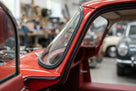 A-post seal fitted along windscreen frame of a red classic Jaguar E-Type
