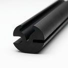 Black rubber glazing section shown end-on with twin channels, studio shot