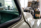 Windscreen seal fitted to the pillar of an unrestored grey classic car