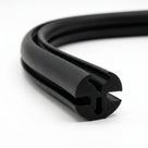 Black EPDM glazing weatherstrip coiled, showing the twin-bulb extruded profile
