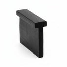 Short block of black T-section rubber extrusion standing on end, studio shot
