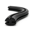 Black EPDM weatherstrip coiled in an S-shape, twin-bulb channel profile visible