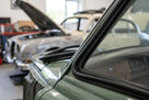 Windscreen seal fitted to the A-post of a green classic Jaguar saloon