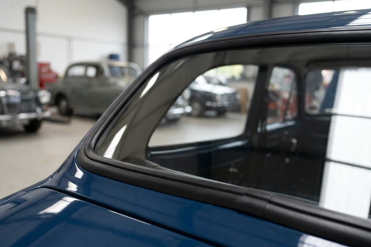 Windscreen seal fitted to the curved corner of a dark blue classic Jaguar saloon
