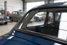 Windscreen seal fitted to the curved corner of a dark blue classic Jaguar saloon