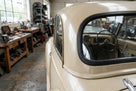 Windscreen seal mounted around the rear corner window of a cream classic car