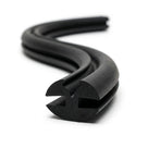 Black EPDM weatherstrip seal coiled in an S-curve, twin-bulb profile visible