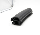Black rubber windscreen seal with double channel and ribbed fin, coiled on white background