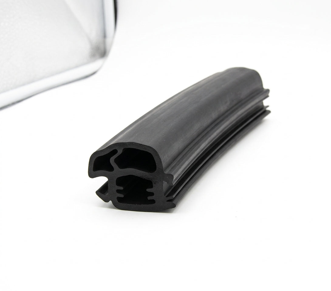 Black rubber windscreen seal with double channel and ribbed fin, coiled on white background