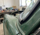 Windscreen seal fitted to the windscreen corner of a green classic Jaguar saloon