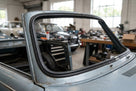Black windscreen rubber seal fitted around a grey classic car's windscreen