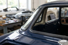 Windscreen seal fitted around the door frame of a dark blue Triumph TR4