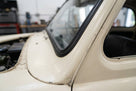 Windscreen seal fitted around the pillar of a cream classic car
