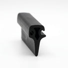 Black rubber T section extrusion shown end-on with a hooked flange