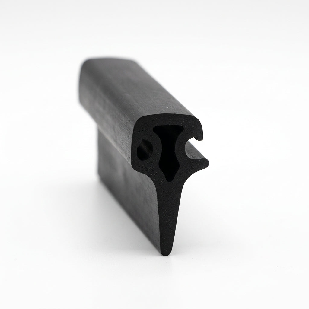 Black rubber T section extrusion shown end-on with a hooked flange