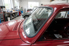 Black windscreen rubber seal fitted around a red saloon's windscreen