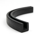 Black EPDM U-channel profile coiled, curved length showing square-ended groove