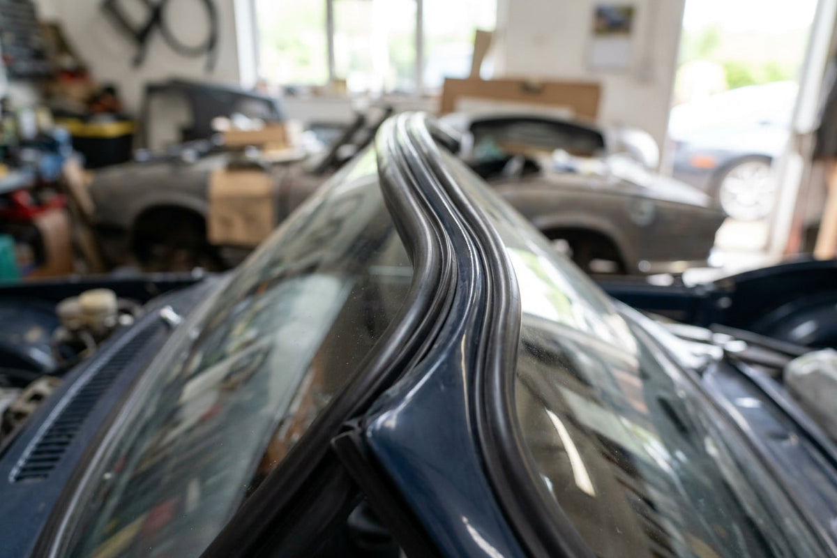 Black windscreen rubber seal fitted along the top edge of a classic car's screen
