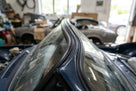 Black windscreen rubber seal fitted along the top edge of a classic car's screen