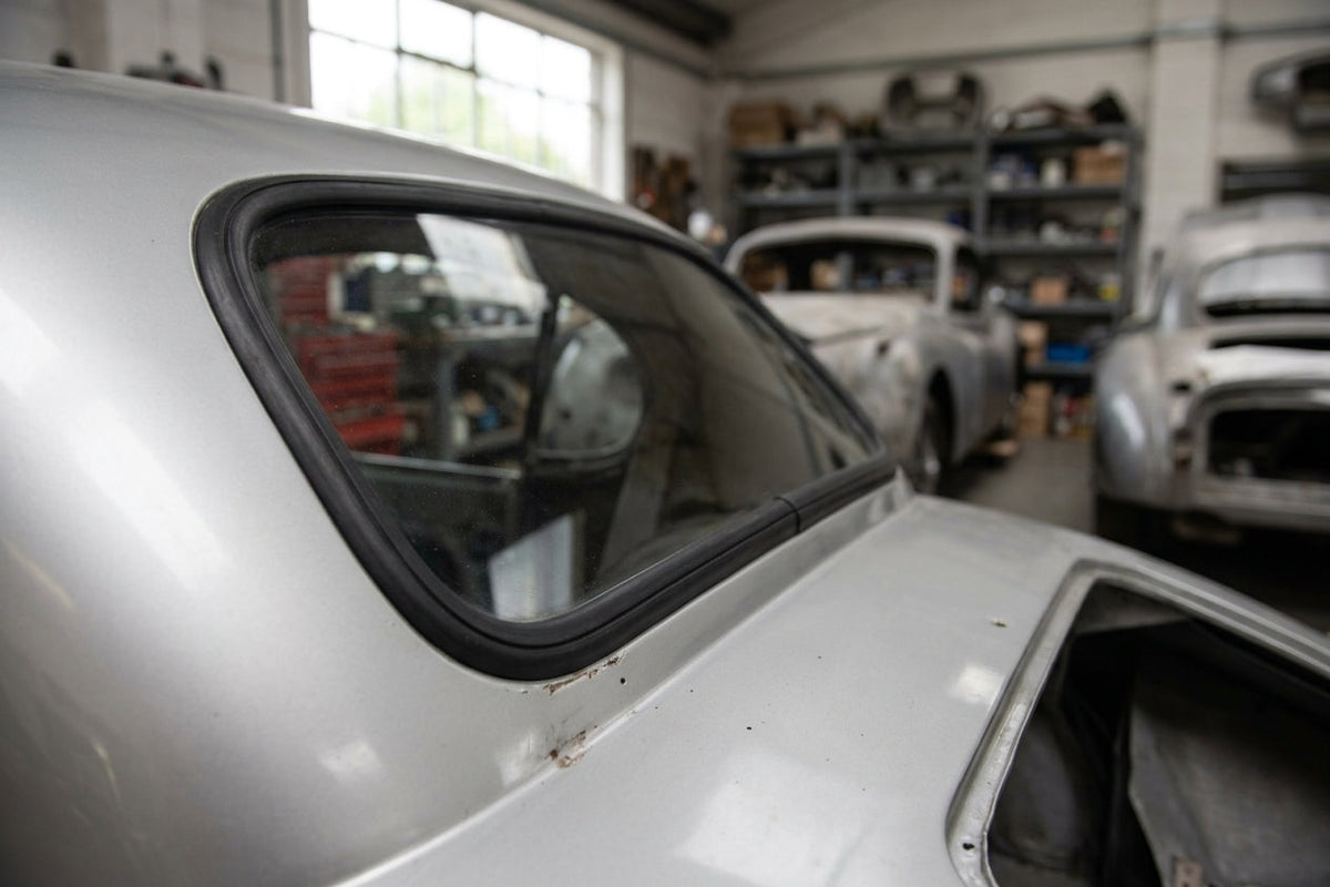 Windscreen seal fitted to the rear window corner of a silver Jaguar XK120