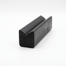 Black rubber block extrusion with twin-peak top, angled studio shot