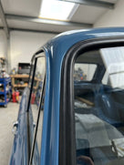Windscreen seal runs along the rear pillar of a blue classic van