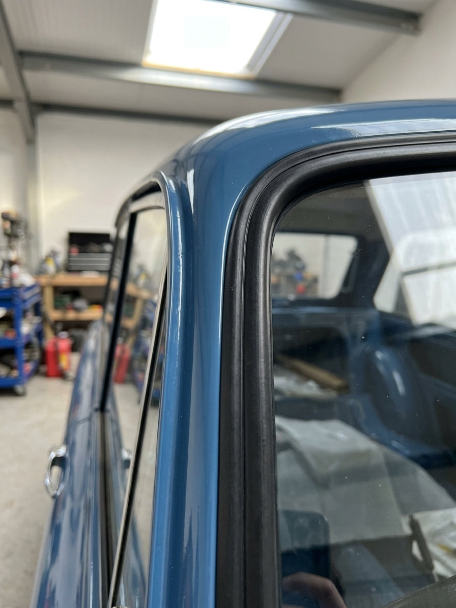 Windscreen seal runs along the rear pillar of a blue classic van