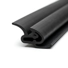Black rubber hardtop seal with curled lip and hook, coiled length on white background