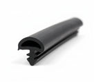 Black rubber seal profile with bulb section and fir-tree fixing legs, studio shot