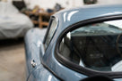 Windscreen seal fitted to the hardtop rear window corner of a light blue Jaguar E-Type