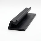 Black rubber door seal with hooked lip and flat flange, angled studio shot