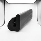 Black rubber U-channel trim seal with serrated grip, angled studio shot