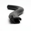 S-curved length of black rubber block section showing hollow bulb and side hook
