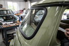 Black windscreen rubber seal fitted around the rear window of a green Mini Mk2