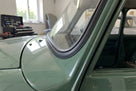 Black windscreen rubber seal fitted around the screen of a green early Mini