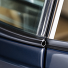 B-post seal close-up on a dark blue classic Jaguar's window frame