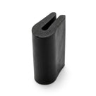 Black neoprene U-channel profile standing upright, plain white background shot of rounded block