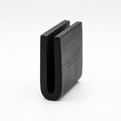 Black EPDM U-channel profile standing upright, plain white background shot of U-shaped block
