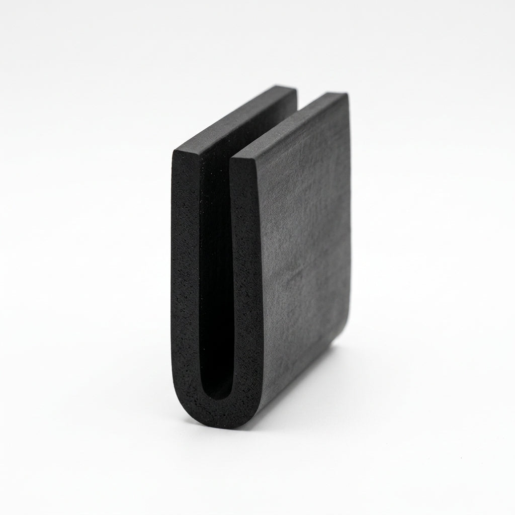 Black EPDM U-channel profile standing upright, plain white background shot of U-shaped block