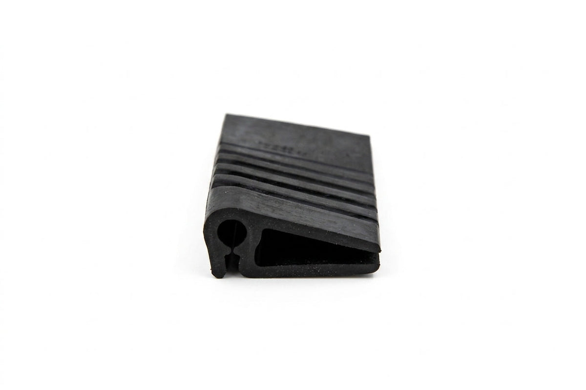 Black ribbed rubber drain flap with triangular cross-section, studio shot
